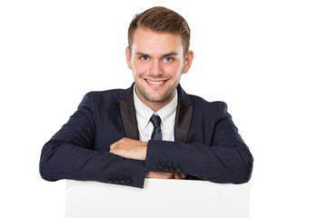 Businessman standing  next to a blank white billboard