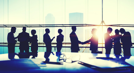 Wall Mural - Silhouettes of Business People Meeting Handshake Concept