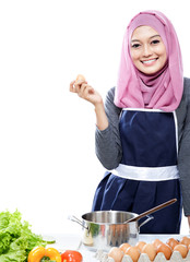 young woman preparing making a meal with ingredients on the tabl