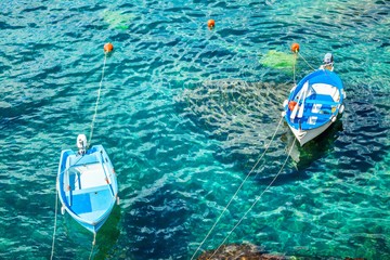 Two old fishing boats in the turquoise waters