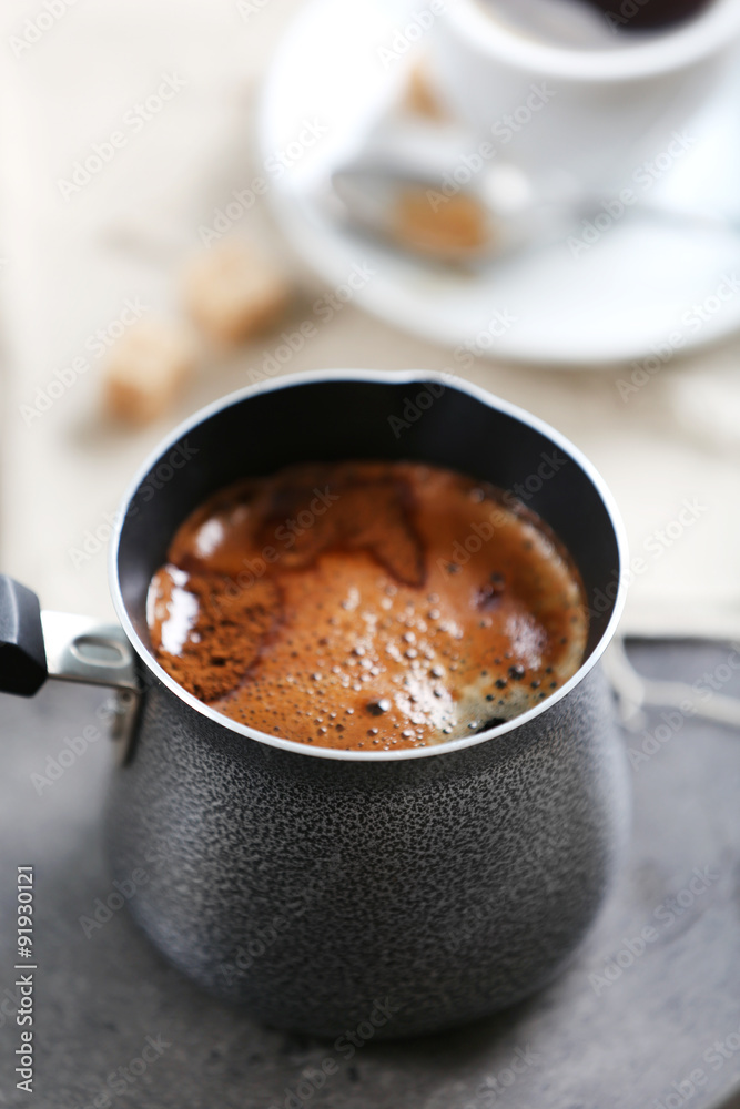 Turk of flavored coffee on table with napkin, closeup