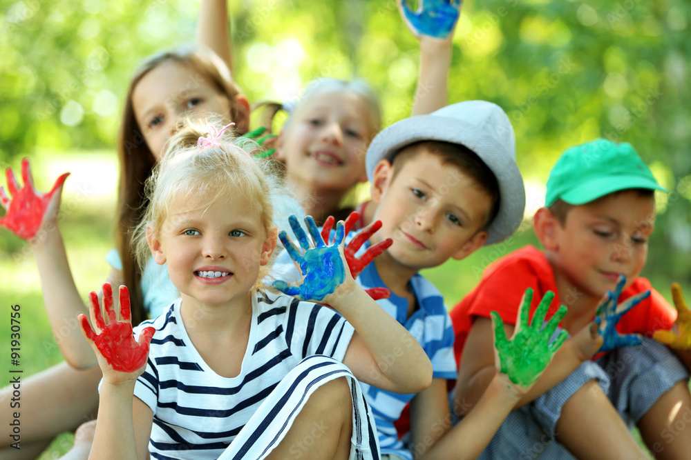 Happy active children with bright colored palms in park