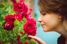 Beautiful Woman Smelling Red Roses