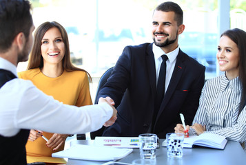 Wall Mural - Business people shaking hands, finishing up a meeting