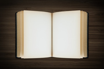 Open book on wooden background