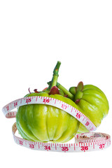 Wall Mural - Garcinia cambogia with measuring tape, isolated on white 