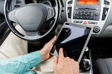 Poster - close up of young man with tablet pc driving car