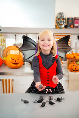 Wall Mural - Funny girl in halloween bat costumein with mouse toys