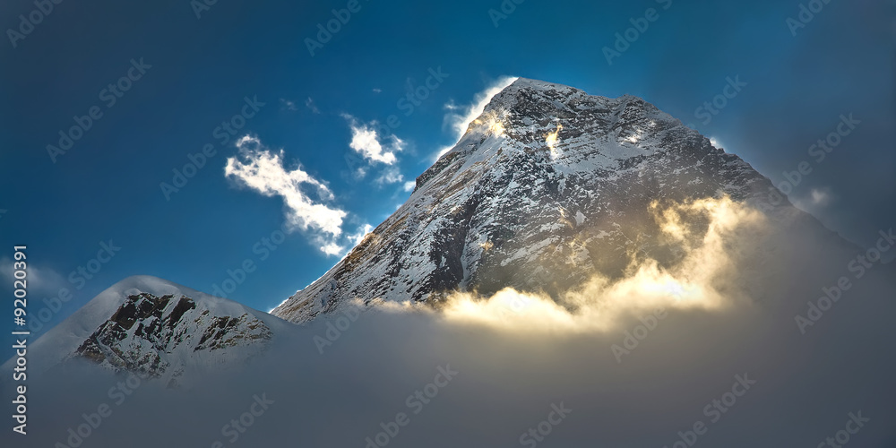 The peak of the highest mountain in the world - Mt. Everest in the light of the first sunrays. - obrazy, fototapety, plakaty 