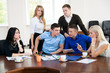 © kanzefar - Young businessmen  at a business meeting