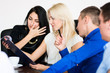 © kanzefar - A group of young people in a meeting at office sitting