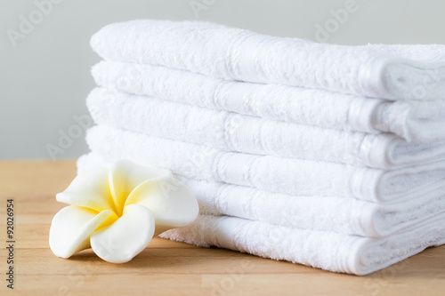 Fotografie, Obraz Plumeria flower with stack of white towel
