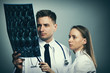 © haveseen - Medical doctors team with MRI spinal scan
