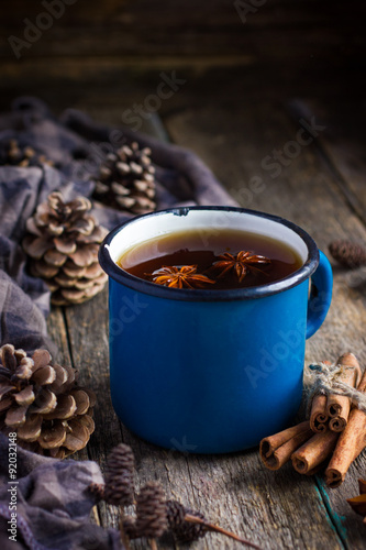 Fotografie, Obraz Hot spicy tea with anise and cinnamon in vintage blue enamel mug