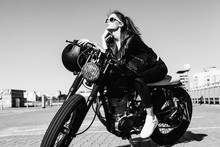 Biker Girl Sitting On Vintage Custom Motorcycle