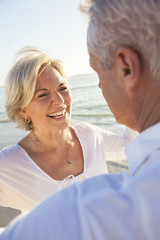 Wall Mural - Happy Senior Couple Walking Holding Hands Tropical Beach