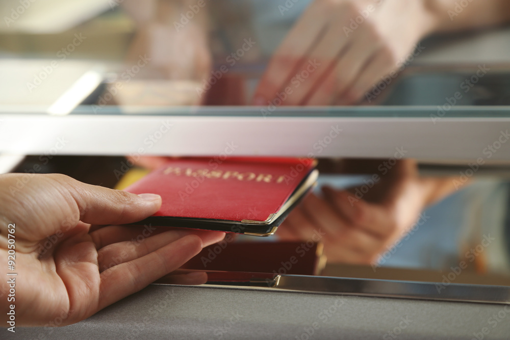 Woman buying tickets with passport at box office