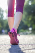 Close-up legs of a girl walking in the park