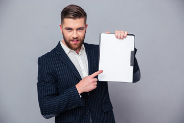 Wall Mural - Handsome businessman showing blank clipboard