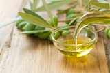 Fototapeta  - olive oil on brown wooden background