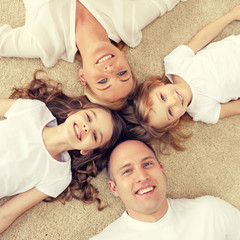 Wall Mural - parents and two girls lying on floor at home