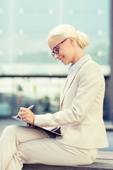 Sticker - young smiling businesswoman with notepad outdoors