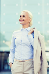 Sticker - young smiling businesswoman over office building