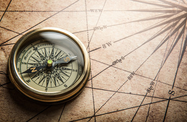 Fototapete - Old compass on vintage map. Retro stale.