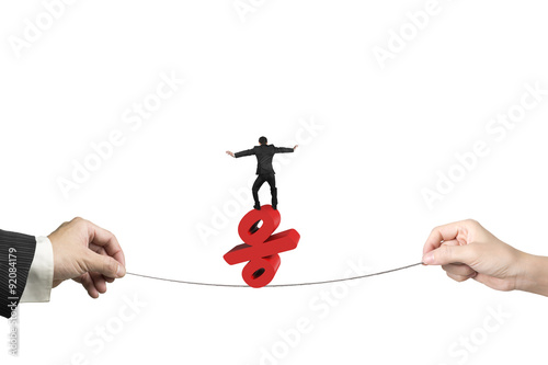 Fotografía Two hands pulling rope businessman balancing percentage sign