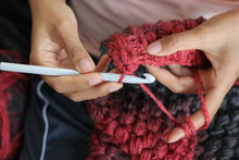 A Girl Showing How To Crochet