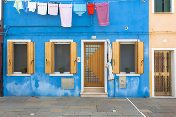 Blue colorful house of Burano Island with laundry, Venice, Italy