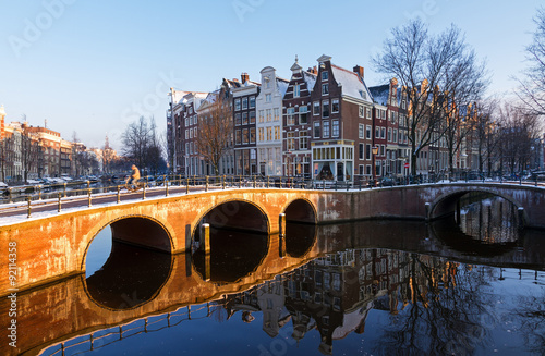 Beautiful early morning winter view on one of the Unesco world heritage city canals of Amsterdam, The Netherlands Poster