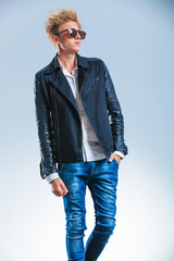 Poster - man walking and posing while wearing jeans and leather jacket