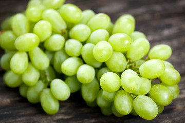  Green grape, close up  on old wooden table. background. selected focus