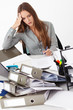 © Dmytro Panchenko - Portrait of beautiful business woman surrounded by big pile of d