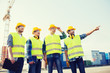 © Syda Productions - group of smiling builders with tablet pc outdoors