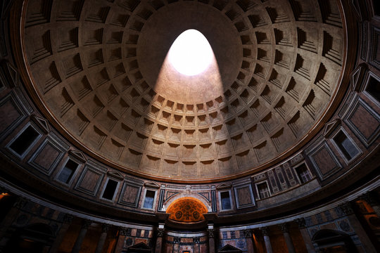 the pantheon, rome, italy. light shining through an oculus in the ceiling