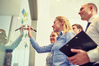 © Syda Productions - smiling business people with marker and stickers