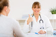 © cherryandbees - Young woman at her doctors receiving good news about her health