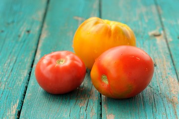 Two red one yellow tomatoes