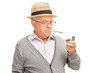 Senior man lighting up a joint with a lighter