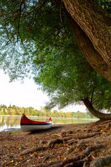 Canvas Print - Red canoe on beach at river Danube