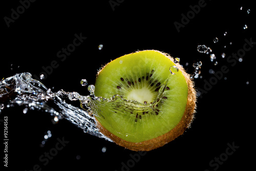 Fotografie, Obraz Kiwi in water splash on black background