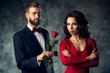 Young elegant couple with rose