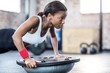 © Wavebreak Media - Young woman exercising in gym