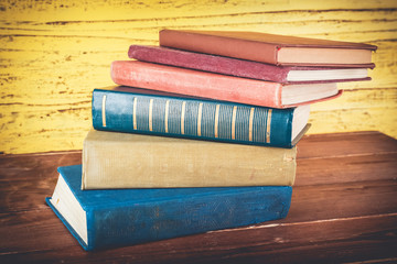 Canvas Print - Stack of books on wooden background