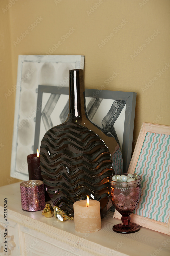Modern vase with decor on fireplace in room