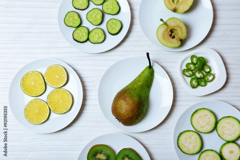 Different products on saucers on wooden table, top view