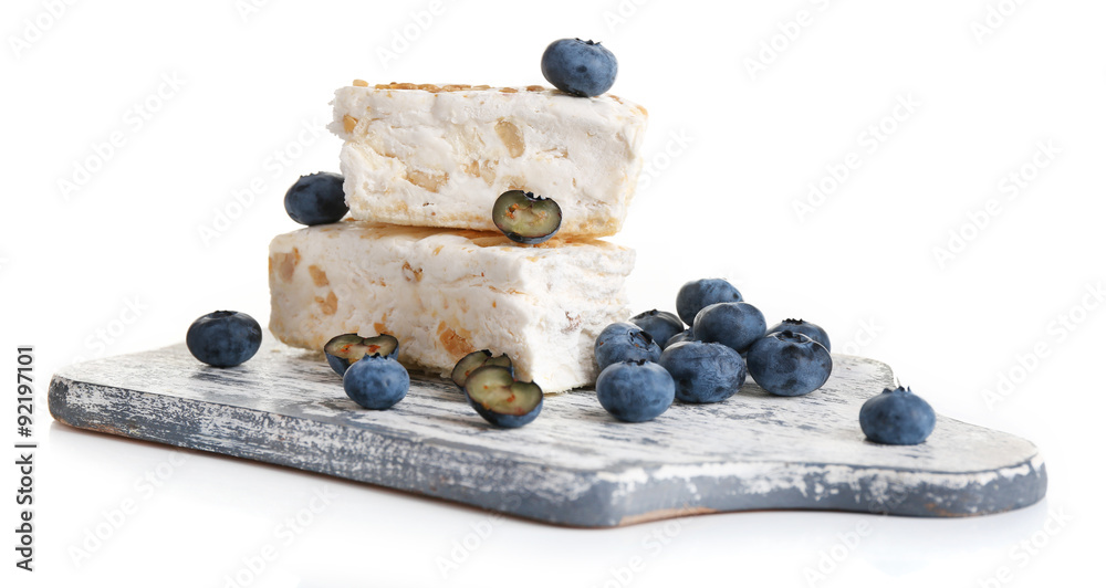 Sweet nougat with hazelnuts and blueberries isolated on white