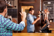 © Yakobchuk Olena - Attractive young guy orders lager in pub